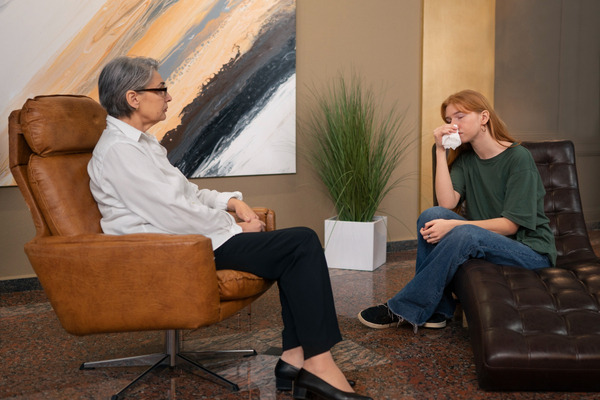 Young woman crying during session with therapist