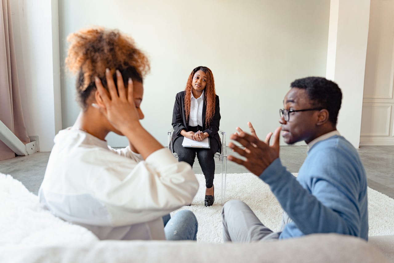 A couple arguing in front of the marriage counselor