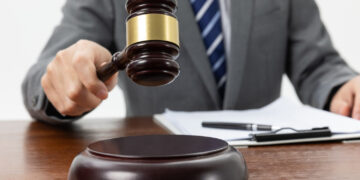Judge holding a gabel on the table
