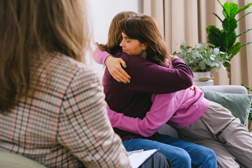 a woman hugging each other with the help of court-therapy session