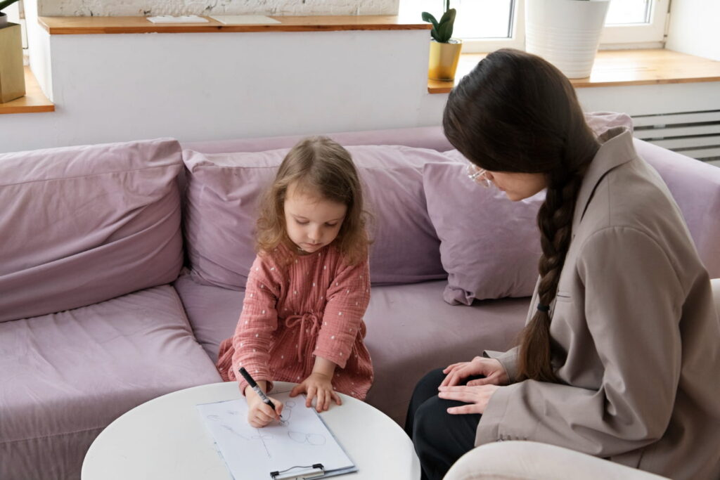 A psychologist helping a child with developmental issues
