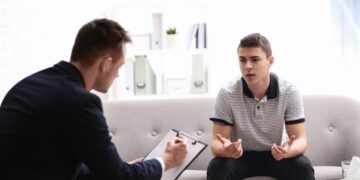 Man participating in a clinical assessment conducted by a psychologist.
