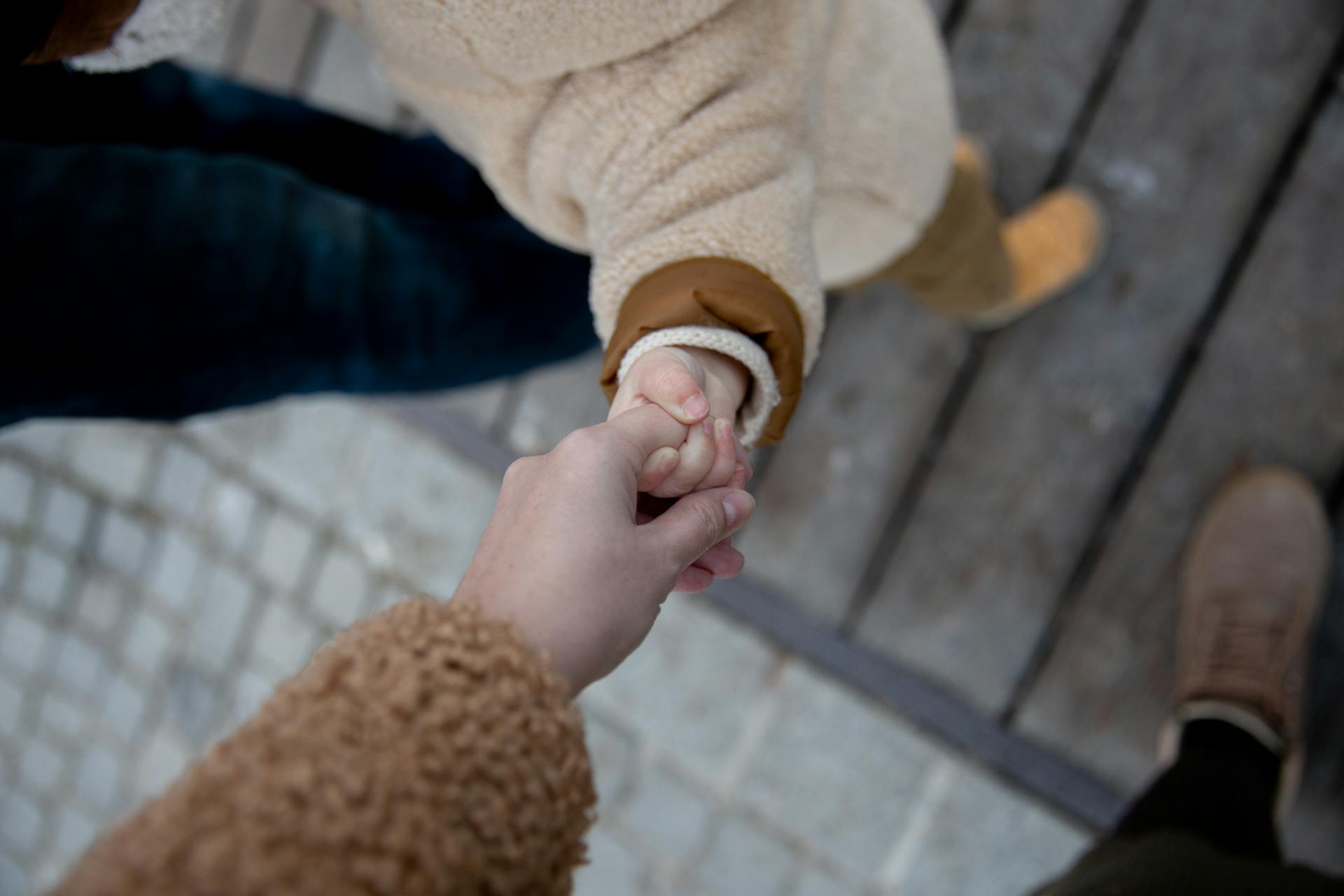 Child holding her mother's hand