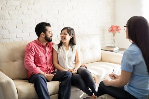 Couple meeting with a therapist as part of reunification therapy.
