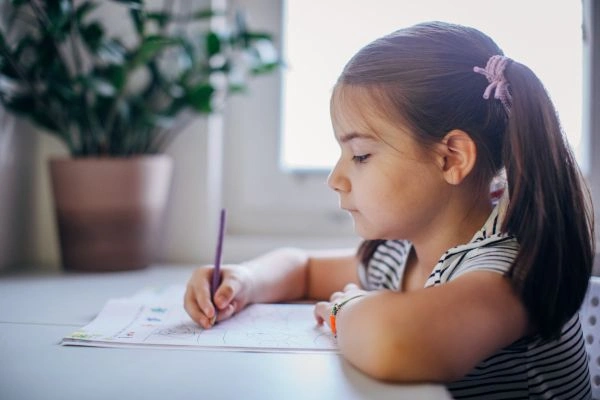 Child struggling to write on paper