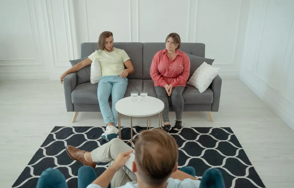 A married couple sharing their concerns with a licensed family therapist during counseling