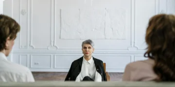 A professional therapist counseling a married couple during a family reunification therapy session